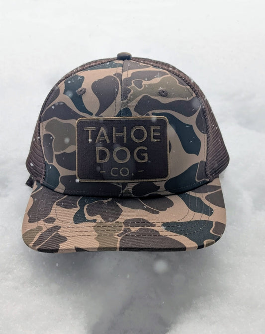 Camo trucker hat featuring Tahoe Dog Co. logo (aka "The Rex")