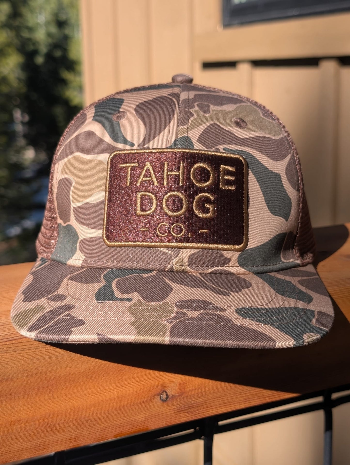 Camo trucker hat featuring Tahoe Dog Co. logo (aka "The Rex")