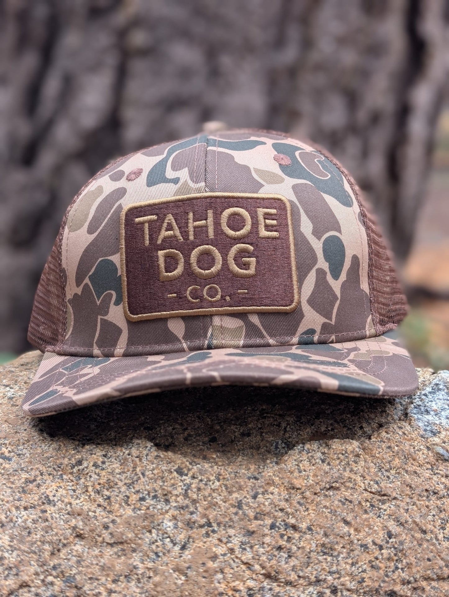 Camo trucker hat featuring Tahoe Dog Co. logo (aka "The Rex")